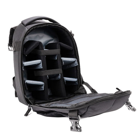 Open black camera backpack interior with padded dividers and adjustable strap
