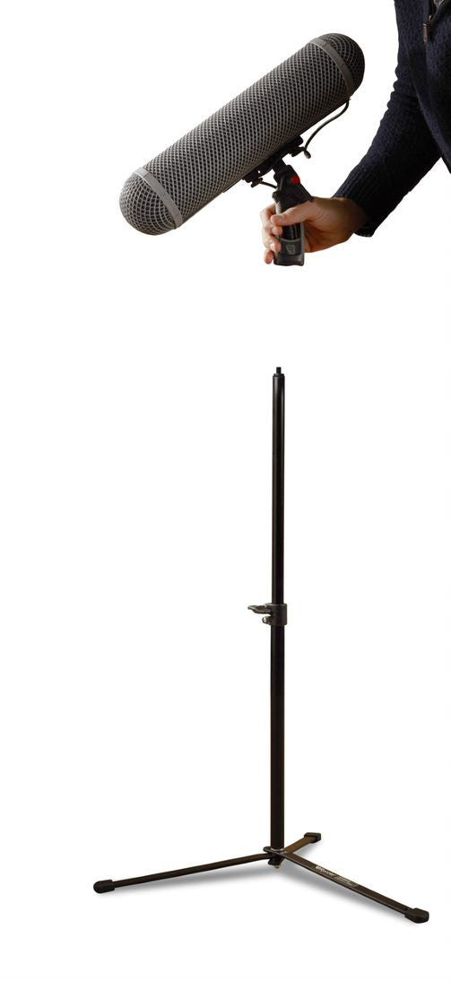 Hand attaching a microphone to a black 3/8" threaded stand with tripod base
