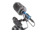 Furry windscreen over shock mount; blue center coupling on camera rig