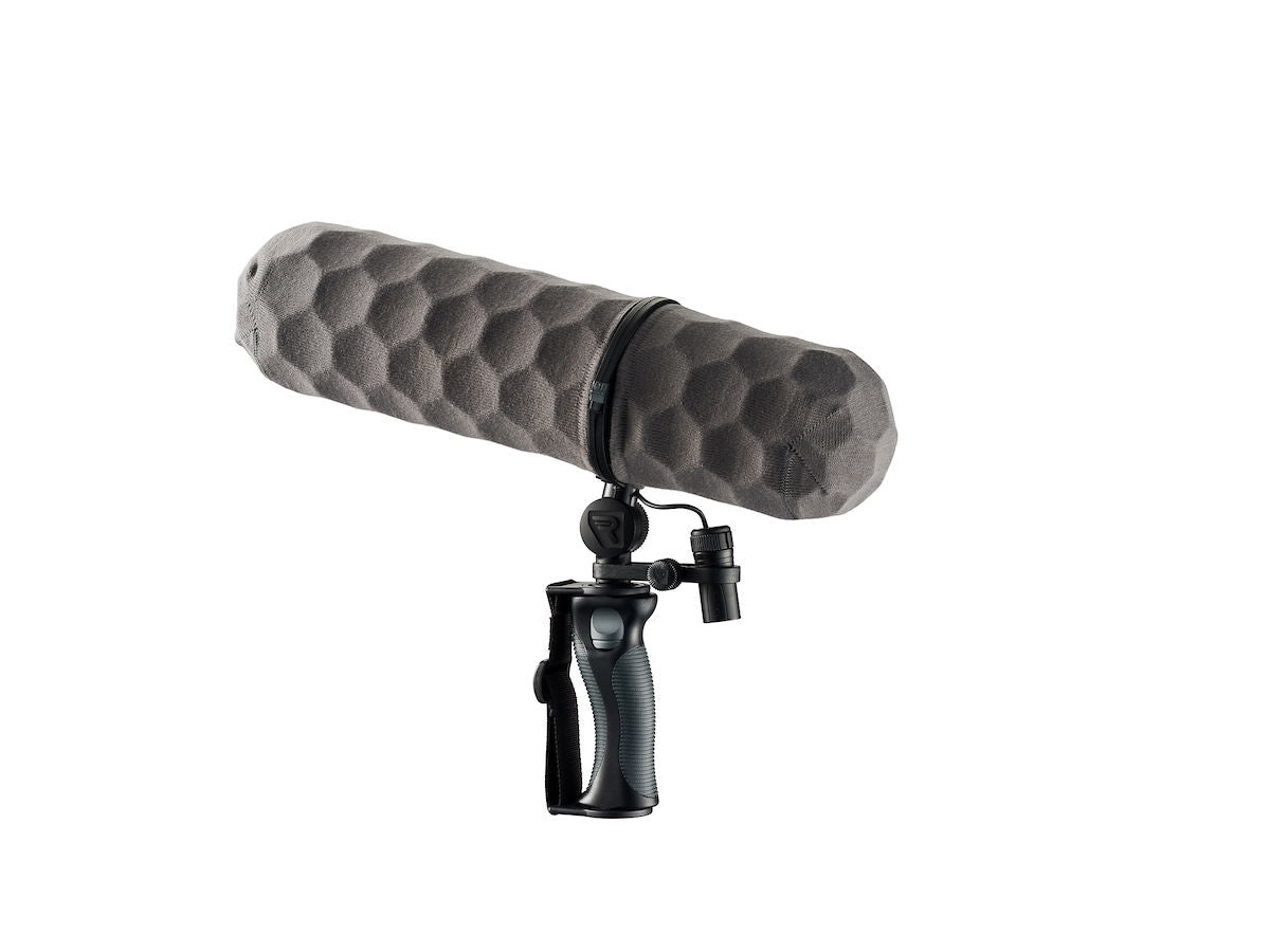 Gray foam windscreen for shotgun microphone, mounted on a handheld shock mount