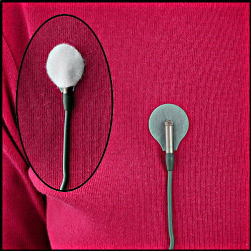 Lavalier mic sticker pad on red fabric with foam top and cable connection