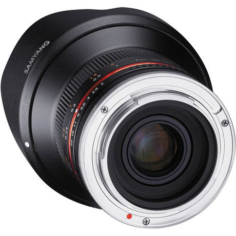 Wide-angle mirrorless lens with silver mount ring and black barrel, front glass