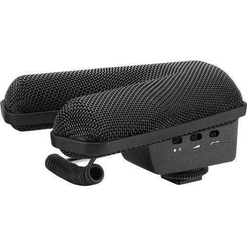 Black stereo shotgun microphone with side housing, top controls, and coiled cable