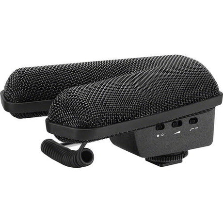 Black stereo shotgun microphone with side housing, top controls, and coiled cable