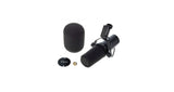 Broadcast microphone with foam windscreens and round base, angled front view