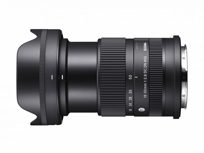 Black 18-50mm f/2.8 DC DN lens, angled side view showing zoom ring and mount