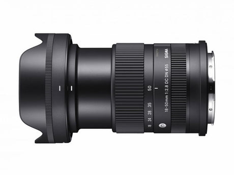 Black 18-50mm f/2.8 DC DN lens, angled side view showing zoom ring and mount