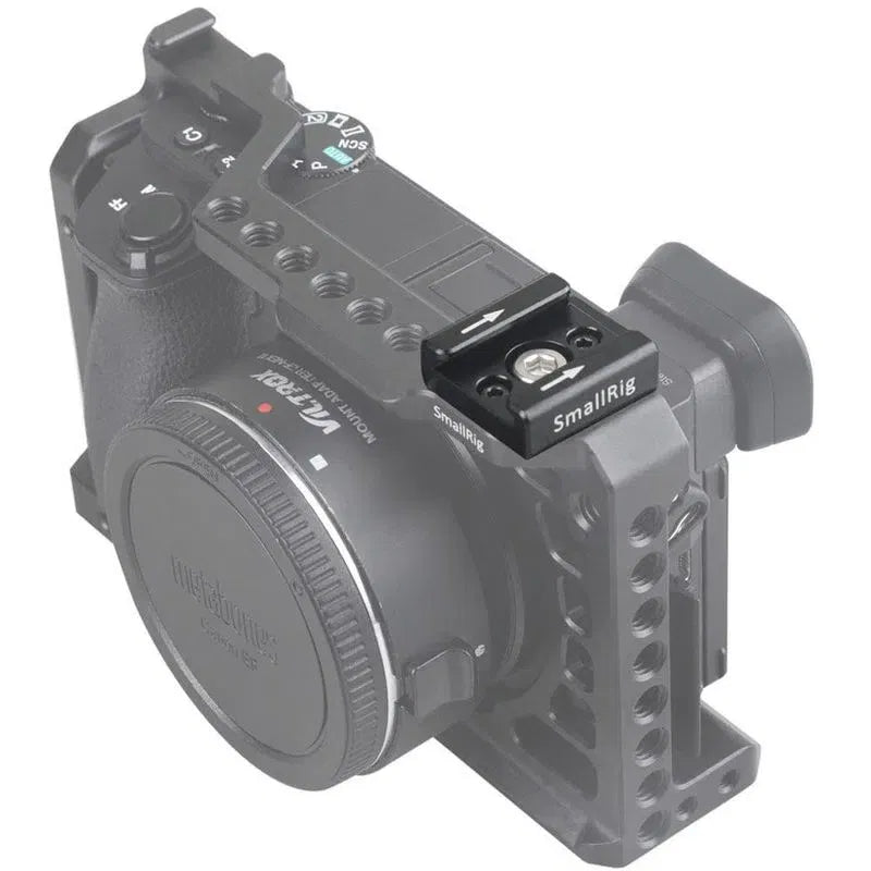 Metal mounting bracket attached to a camera body with multiple adjustment screws