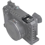 Metal mounting bracket attached to a camera body with multiple adjustment screws