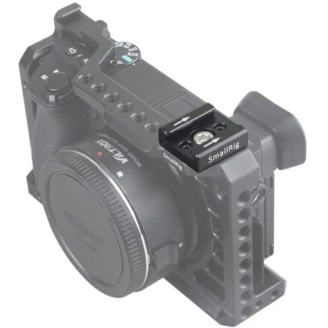 Metal mounting bracket attached to a camera body with multiple adjustment screws