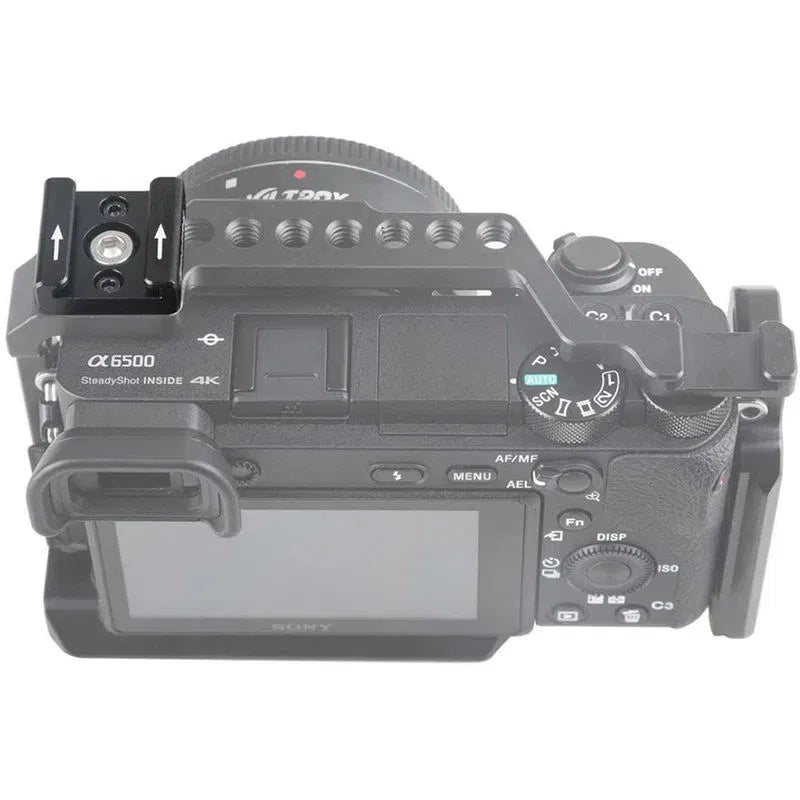 Camera with top-mounted accessory bracket and metal rails, showing mounting holes
