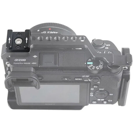 Camera with top-mounted accessory bracket and metal rails, showing mounting holes
