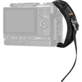 Black camera hand strap with wrist loop attached to a compact camera