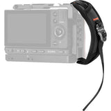 Black camera hand strap with wrist loop attached to a compact camera