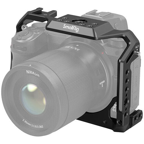 Nikon Z camera fitted with a dark gray cage, side cutouts and mounting points visible