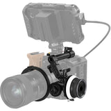 Follow focus mounted on camera rig, silver body with black gear and knob