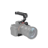 Black half cage with top handle and rail bracket mounted on camera body