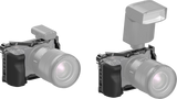 Camera cage kit with top mount and textured handgrip, lens-facing view