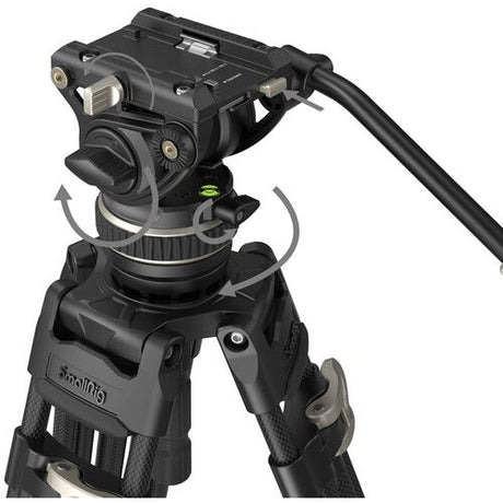 Close-up of fluid video head with adjustment knobs on black tripod