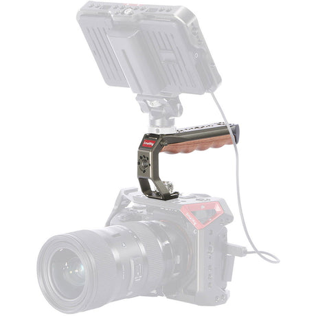 ARRI locating handle with wood grip and pin holes on camera rig