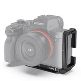 L-bracket mounted on camera side, black metal support with top accessory mount