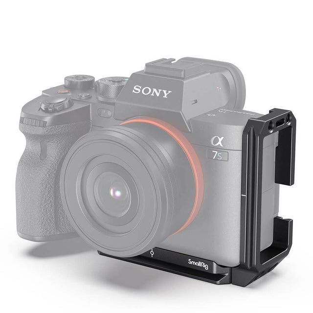 L-bracket mounted on camera side, black metal support with top accessory mount