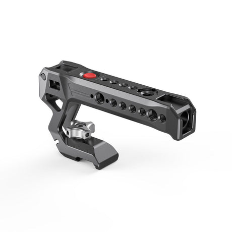 NATO top handle rig with red control button and multiple mounting holes, dark metal