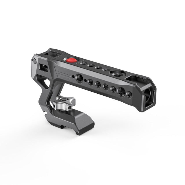 NATO top handle rig with red control button and multiple mounting holes, dark metal