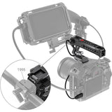NATO top handle attached to camera cage with cables, red button and port openings