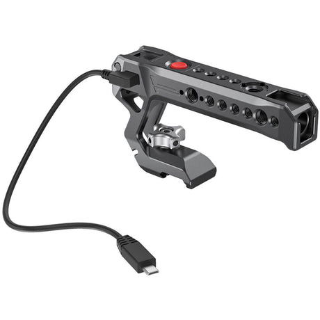 NATO top handle with red button; side ports and cable connector, dark metal body