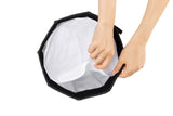 RA-D30 mini parabolic softbox with white diffusion fabric held open by hands