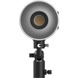Front reflector grille of a bi-color LED video light on a black mounting stand