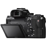 Mirrorless camera angled view with rear LCD open and top dials