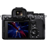 Black mirrorless camera rear view with LCD showing blue and red scene