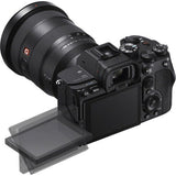 Black mirrorless camera angled with lens and tilting LCD screen