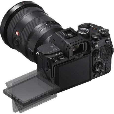 Black mirrorless camera angled with lens and tilting LCD screen