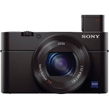 Black compact camera front-right view with raised top flash and centered lens.