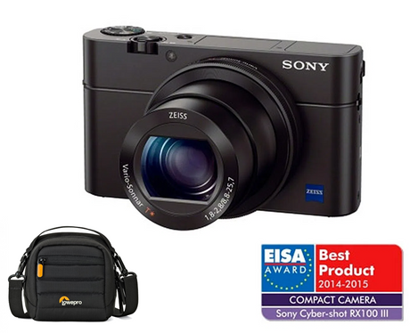 Black compact digital camera with large lens; includes black shoulder bag.