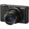 Black compact digital camera with large lens and top control dial