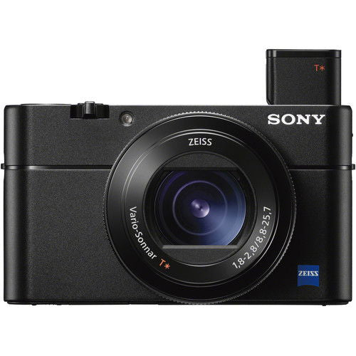 Front three-quarter view of black compact camera with lens