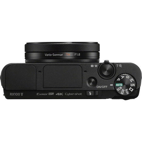 Side view of black compact camera showing zoom lever and mode buttons