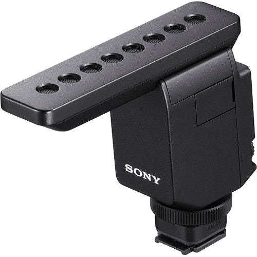 Digital mic with gray furry windscreen, black housing, and top mounting plate