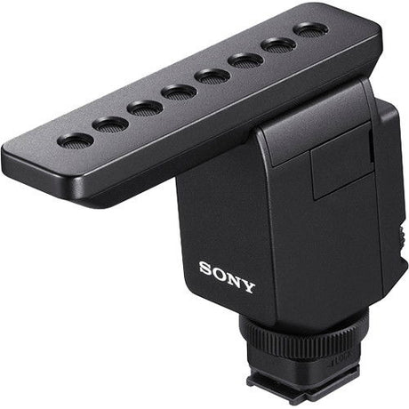 Digital mic with gray furry windscreen, black housing, and top mounting plate