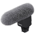 Digital noise-cancelling microphone with gray furry windscreen and black body