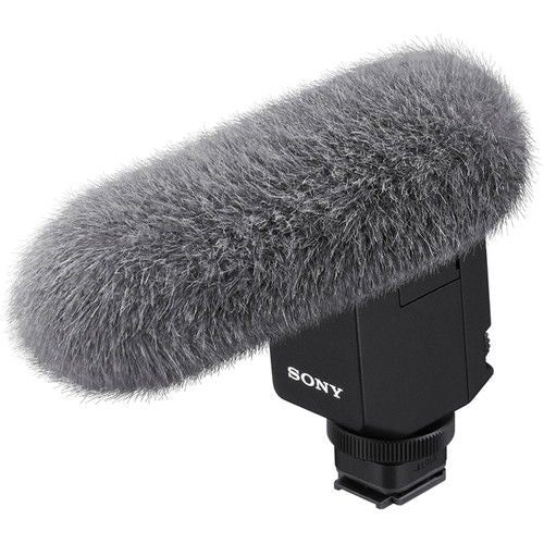 Digital noise-cancelling microphone with gray furry windscreen and black body
