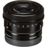 Black 24mm lens angled view showing front glass, distance marks, and ribbed focus ring