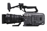 Cinema camera with 28-135mm lens, side view showing lens barrel and controls