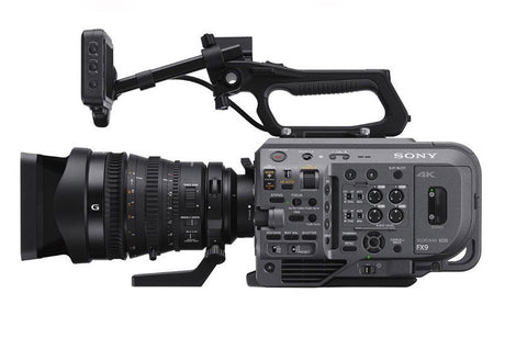 Cinema camera with 28-135mm lens, side view showing lens barrel and controls