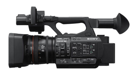 Black 4K professional video camera side profile with lens and top handle