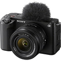 Mirrorless camera with 28-60mm lens, black body, furry microphone windscreen